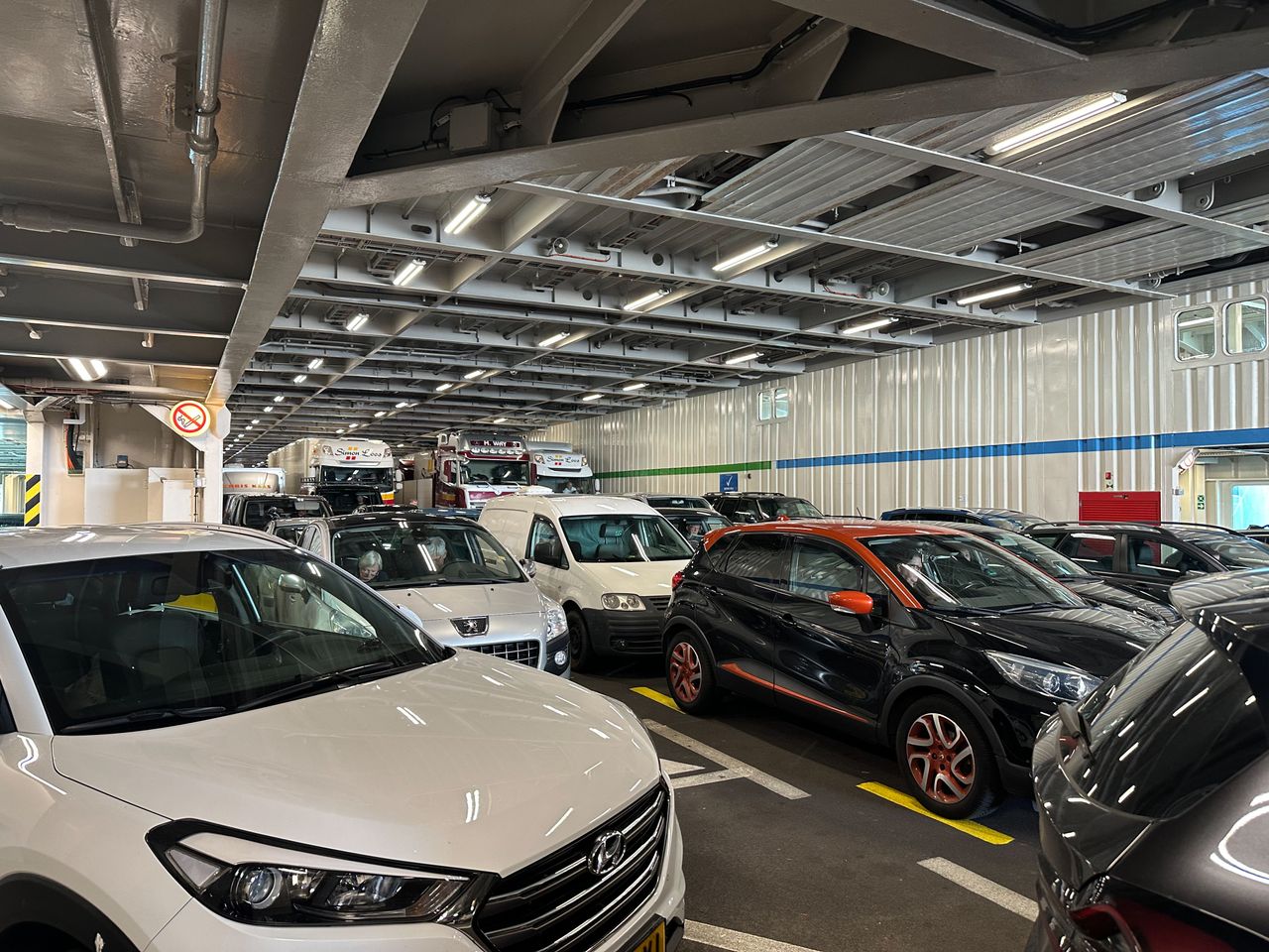 Mastering the First Impression: Your intriguing post title goes here Cars and trucks parked closely together on a ferry deck, emphasizing transportation and travel.