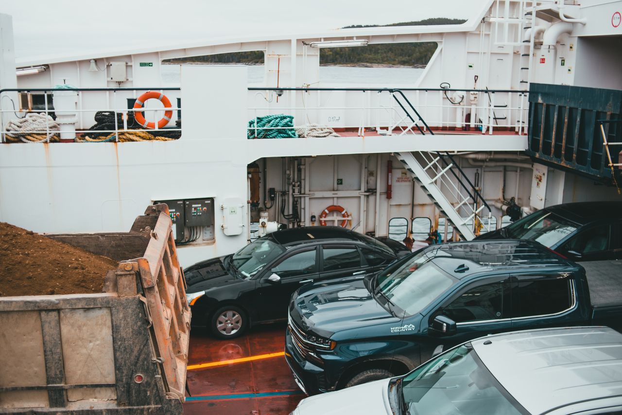 The Art of Drawing Readers In: Your attractive post title goes here A view of vehicles parked on a ferry deck, showcasing transportation by sea.